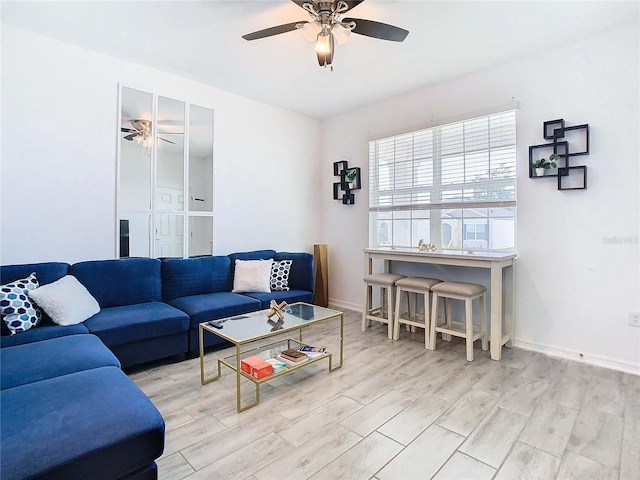 living room featuring ceiling fan and light hardwood / wood-style flooring