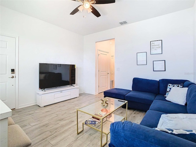 living room with ceiling fan and light wood-type flooring