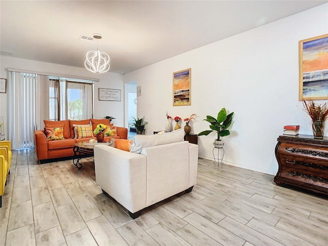 living room with a chandelier and light wood-type flooring