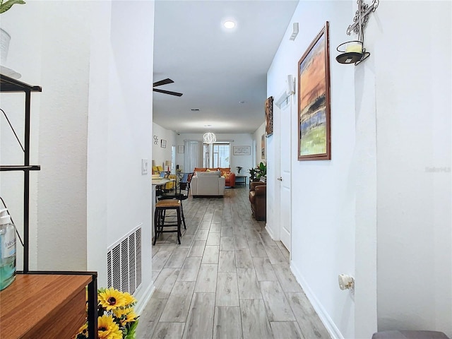 hall with light hardwood / wood-style floors