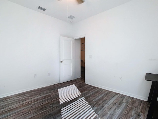 unfurnished room featuring dark wood-type flooring