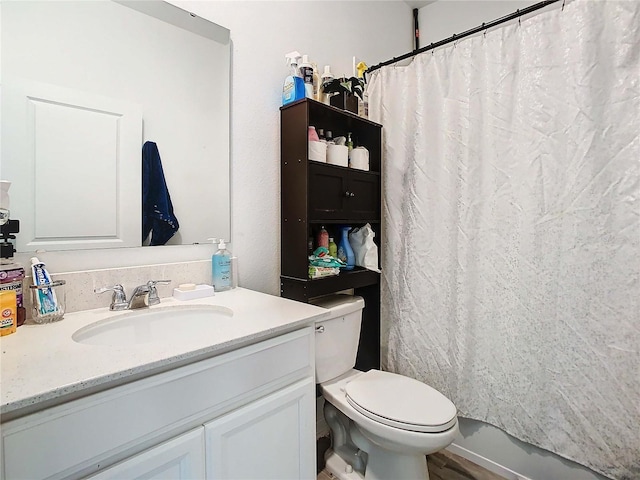 full bathroom with vanity, shower / tub combo with curtain, and toilet