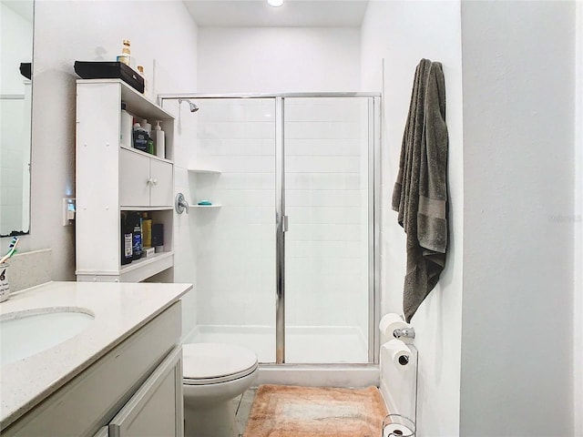 bathroom with vanity, walk in shower, and toilet