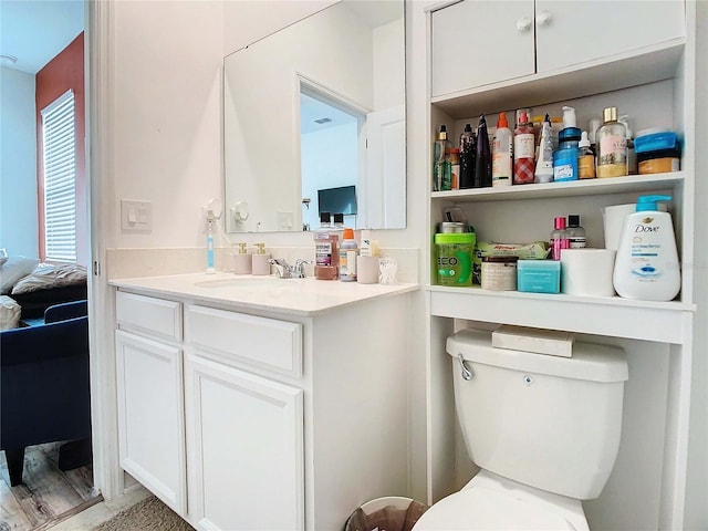 bathroom featuring vanity and toilet