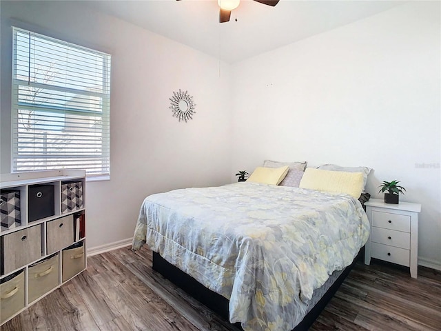 bedroom with ceiling fan and dark hardwood / wood-style floors