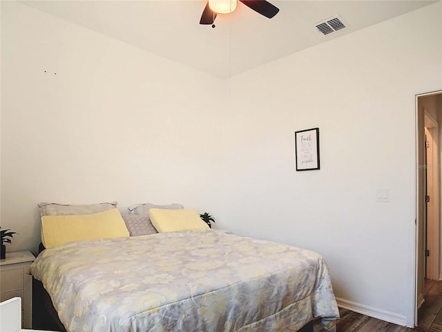 bedroom featuring dark hardwood / wood-style flooring and ceiling fan