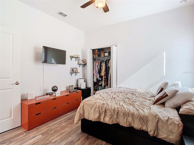 bedroom featuring light hardwood / wood-style flooring, a closet, and ceiling fan