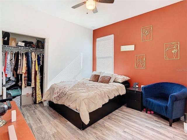 bedroom with a closet, ceiling fan, and light wood-type flooring