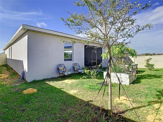 rear view of house featuring a yard