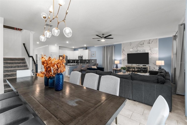 dining room with ceiling fan with notable chandelier and light tile patterned floors