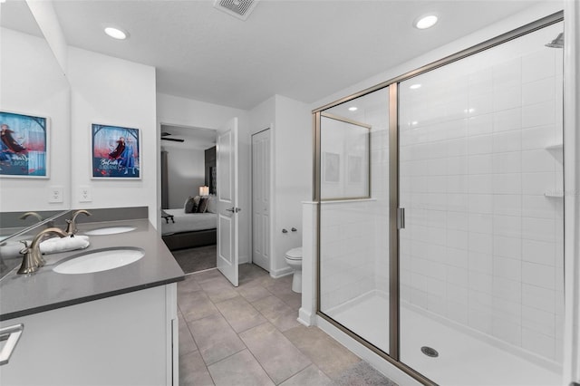 ensuite bathroom featuring toilet, visible vents, a sink, and ensuite bath