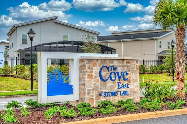community sign featuring fence