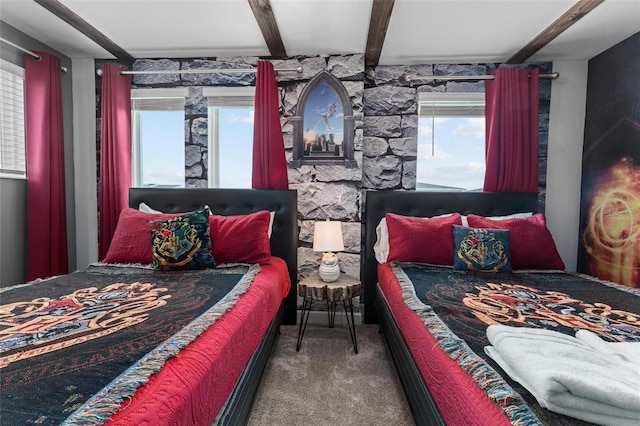 bedroom with beamed ceiling, multiple windows, and carpet