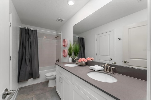 full bathroom featuring toilet, shower / tub combo with curtain, a textured ceiling, and vanity