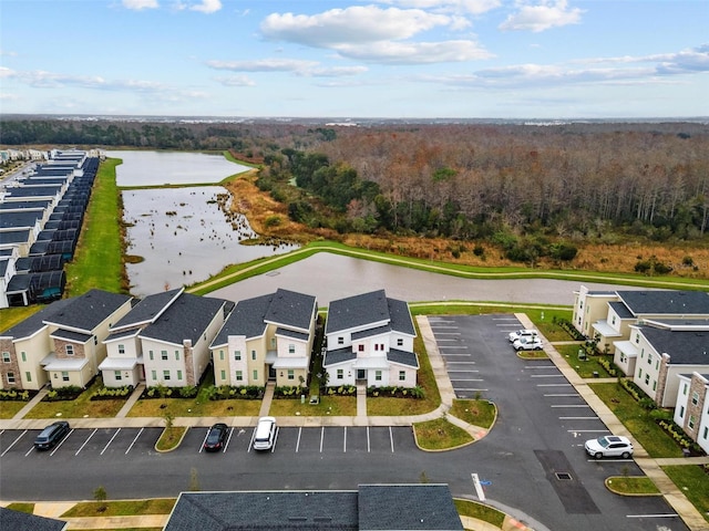 drone / aerial view with a residential view and a water view