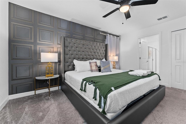carpeted bedroom featuring visible vents, a ceiling fan, and baseboards