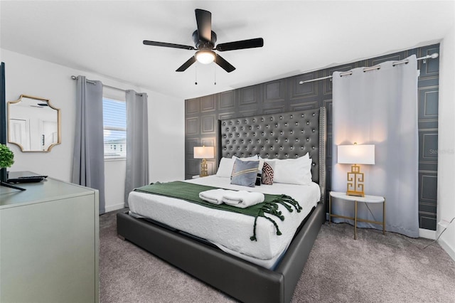 bedroom featuring baseboards, light colored carpet, and ceiling fan