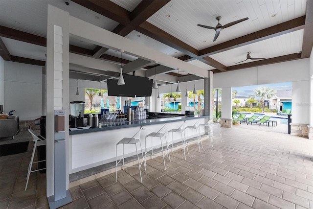 view of patio / terrace featuring ceiling fan and a bar