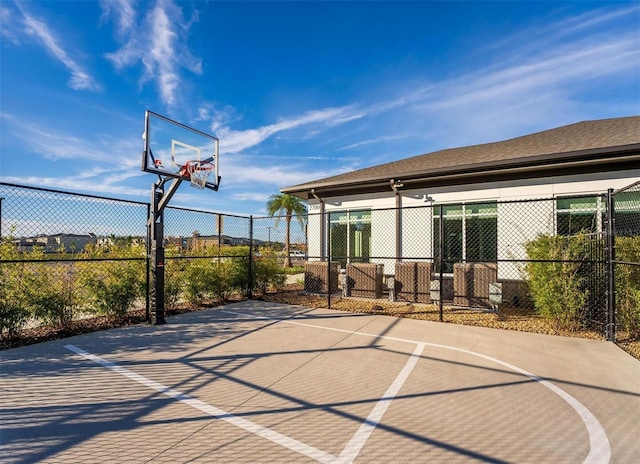 view of basketball court with community basketball court and fence