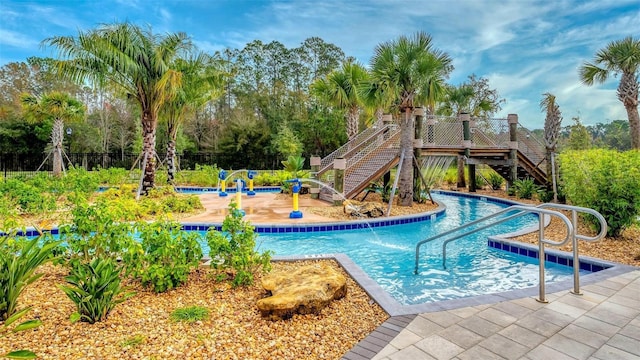 pool featuring stairway and a patio area