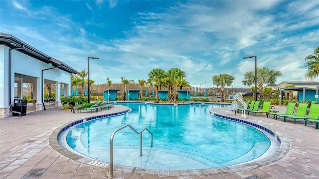 community pool featuring a patio and fence