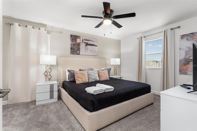 bedroom featuring light carpet and a ceiling fan