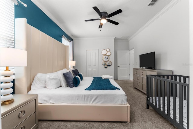 bedroom featuring light carpet, visible vents, ceiling fan, ornamental molding, and a closet