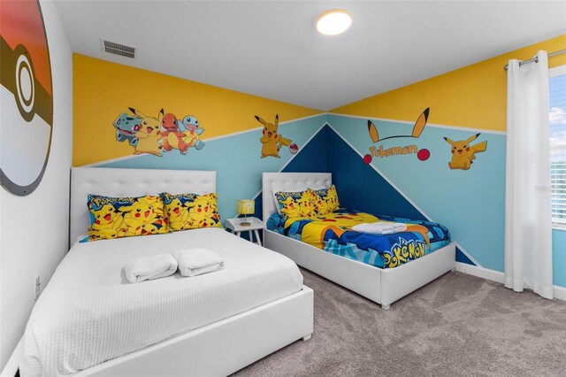 bedroom featuring carpet floors, visible vents, and vaulted ceiling