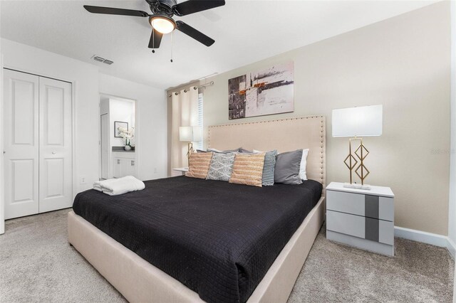 bedroom with carpet floors, visible vents, baseboards, a ceiling fan, and a closet