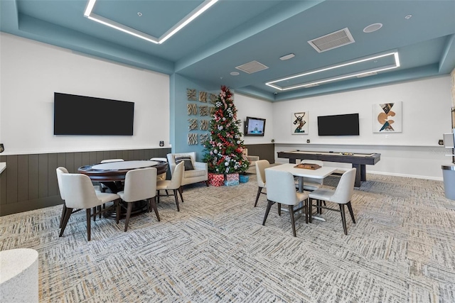 playroom with visible vents, a tray ceiling, and carpet flooring