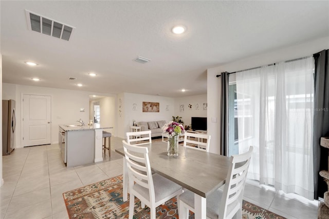 tiled dining area featuring sink