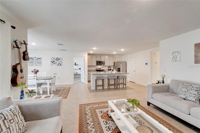 tiled living room with a textured ceiling