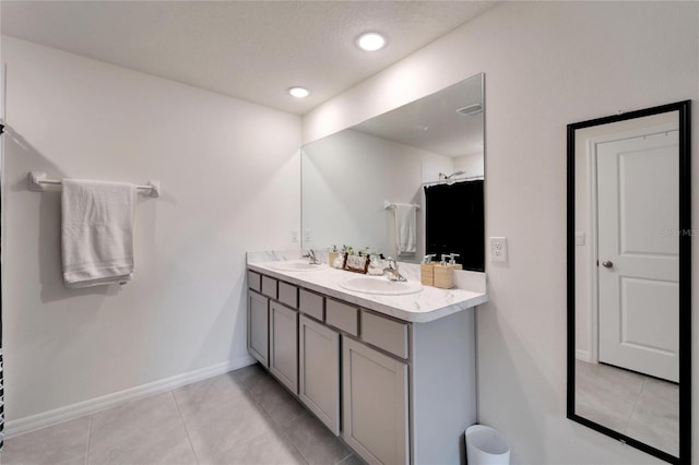 bathroom with dual vanity and tile patterned floors