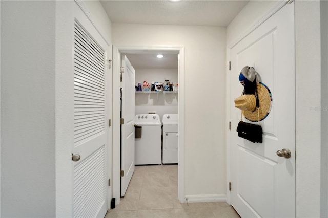 corridor with washer and dryer and light tile patterned floors