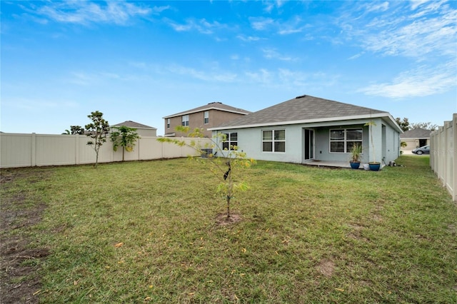 rear view of property with a lawn