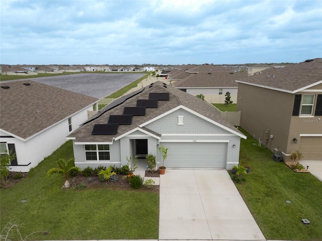 view of front of house featuring a garage and a front yard