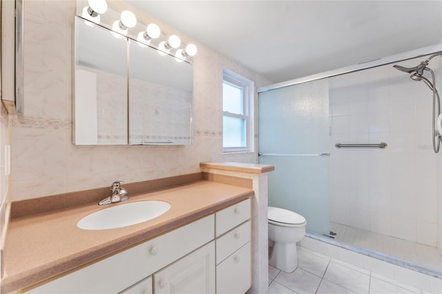 bathroom with vanity, tile patterned flooring, toilet, tile walls, and an enclosed shower