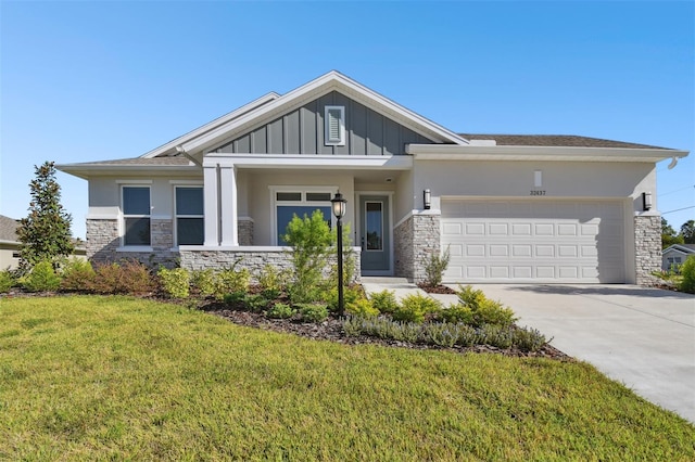 view of front of property with a front yard and a garage