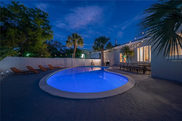 pool at night with a patio