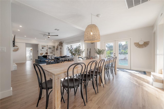 dining room with ceiling fan, light hardwood / wood-style floors, and french doors