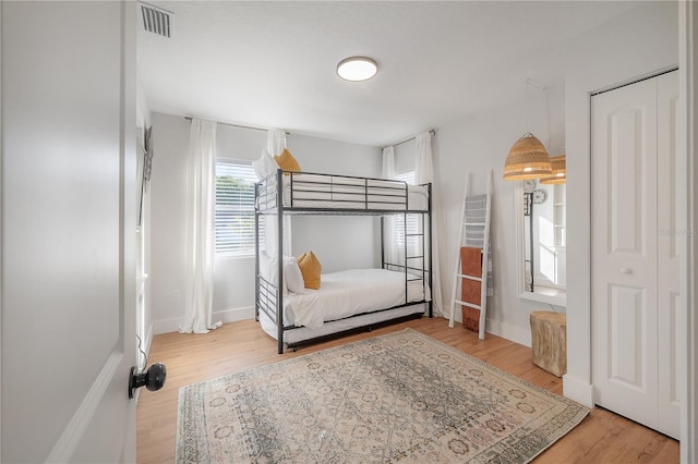 bedroom with light wood-type flooring and a closet