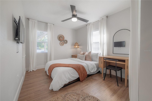 bedroom with ceiling fan and light hardwood / wood-style floors