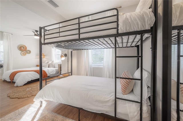 bedroom with ceiling fan and wood-type flooring