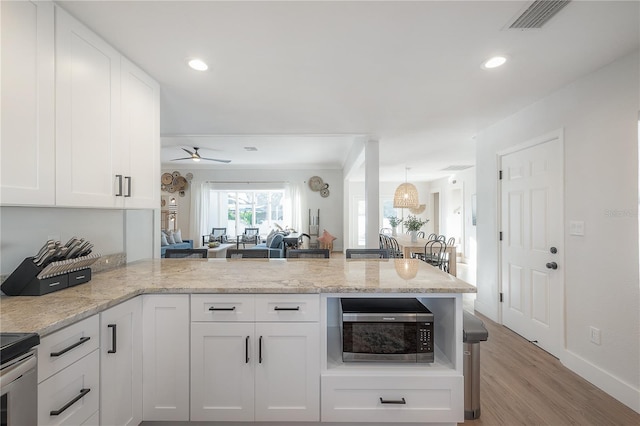 kitchen featuring white cabinetry, light hardwood / wood-style flooring, kitchen peninsula, ceiling fan, and appliances with stainless steel finishes