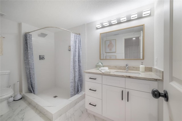 bathroom featuring a textured ceiling, vanity, toilet, and walk in shower