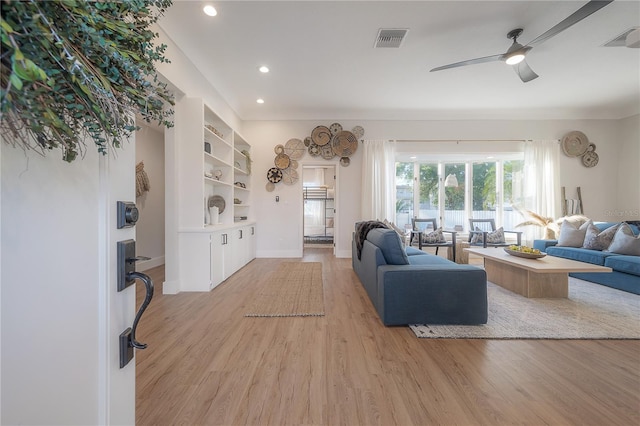 living room featuring light wood-type flooring and ceiling fan