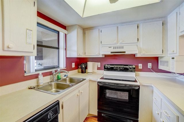 kitchen with sink, white appliances, white cabinetry, and range hood