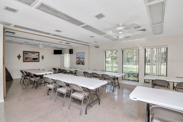 dining room with ceiling fan and a textured ceiling