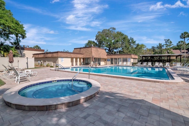 view of swimming pool featuring a patio area and a community hot tub