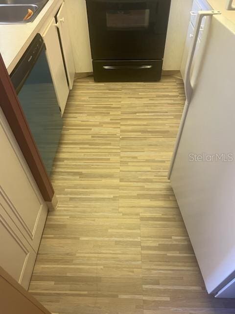 hall featuring light hardwood / wood-style flooring and sink